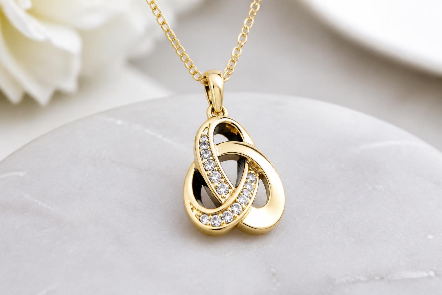 A real-world style photograph of the eternal necklace worn or draped elegantly in clean daylight
