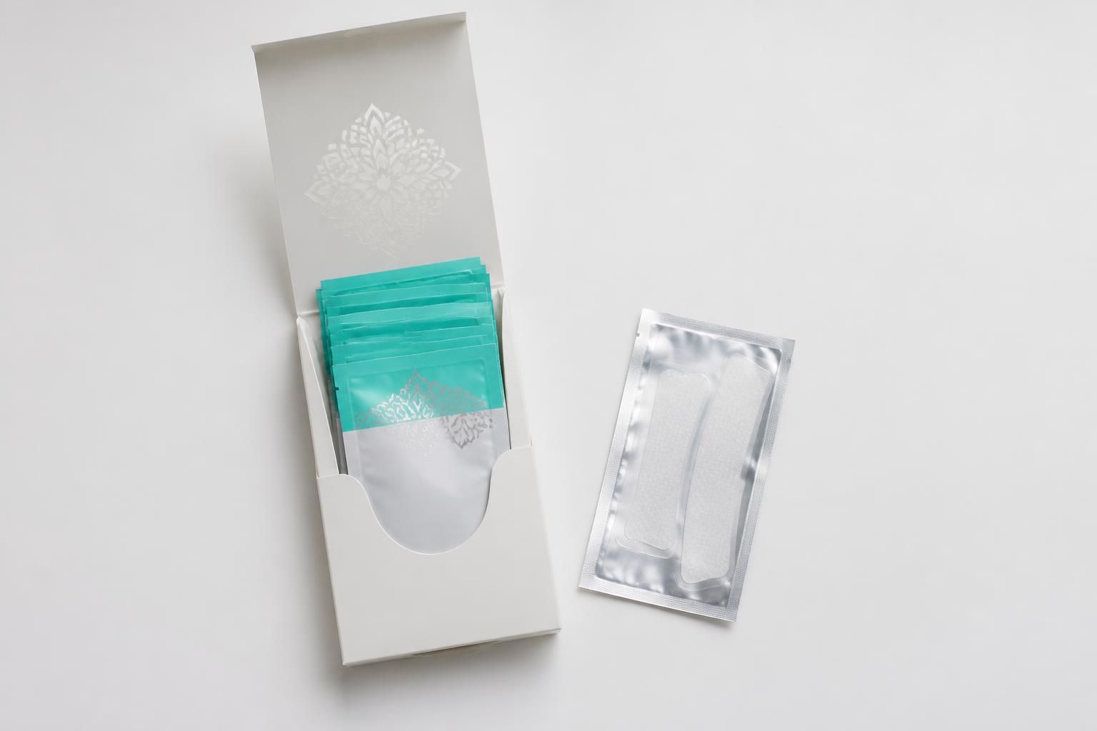 Ordinary whitening strips shown beside GuruNanda on a clean white surface with flat natural lighting