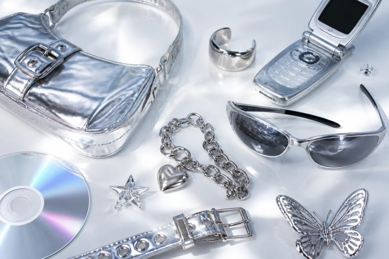 A glossy Y2K collage of chrome accessories